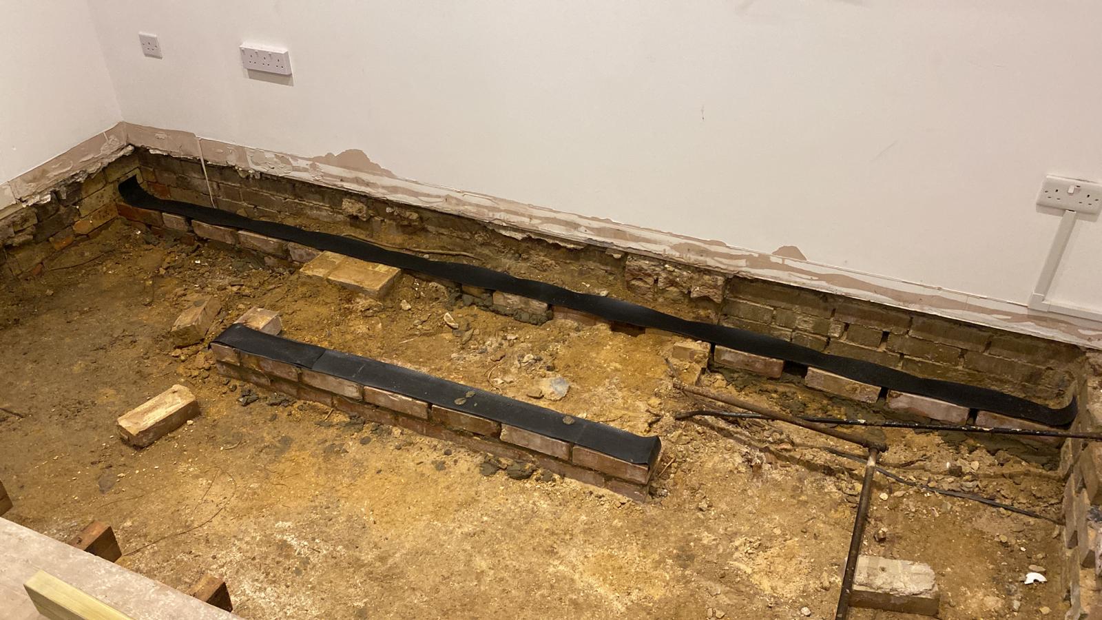 Dry rot outbreak below the floor of a 1920s flat in Cambridge.