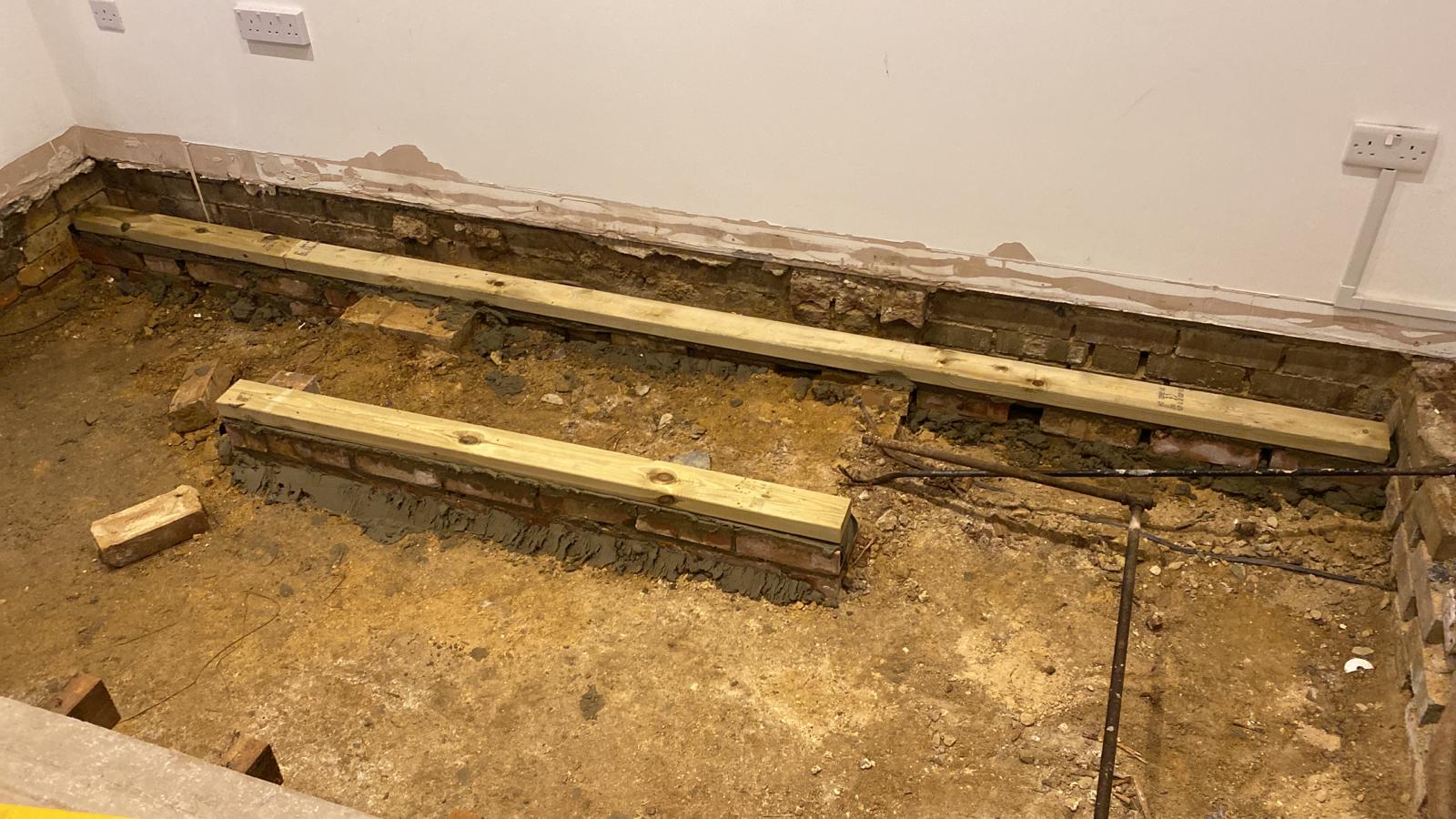 Dry rot outbreak below the floor of a 1920s flat in Cambridge.